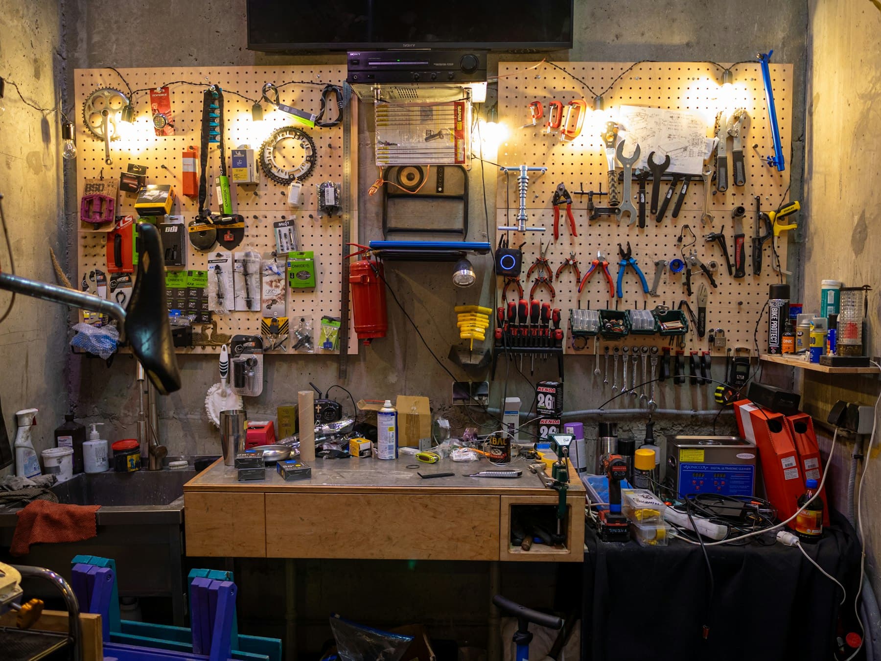 Hand tools arranged on a workshop wall above a workbench